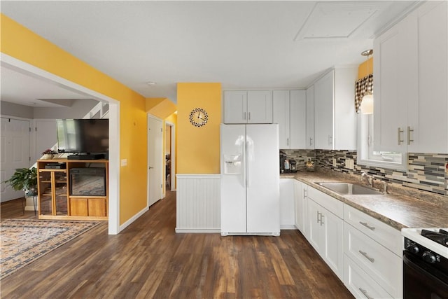 30 Saundra Dr, Westerly, RI 02891 - kitchen featuring white fridge with ice dispenser, dark wood finished floors, a sink, decorative backsplash, and white cabinetry