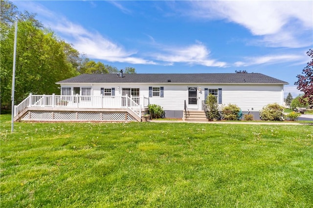 rear view of property with a deck and a yard