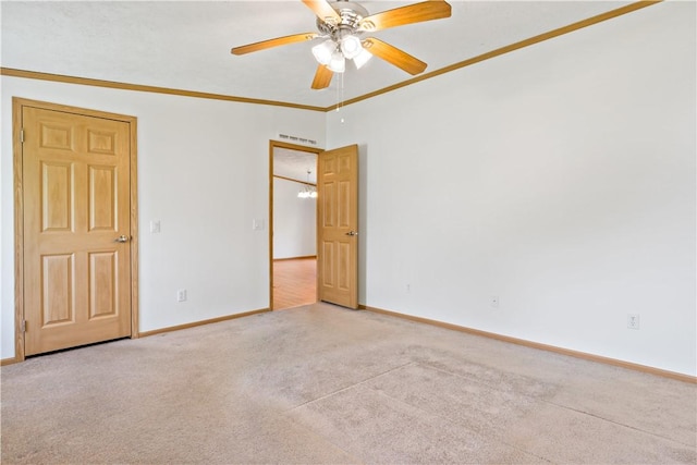 spare room with light carpet, baseboards, ceiling fan, and ornamental molding