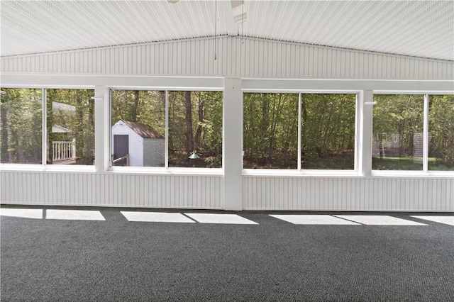 unfurnished sunroom featuring vaulted ceiling