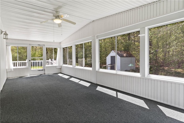 unfurnished sunroom with lofted ceiling and ceiling fan