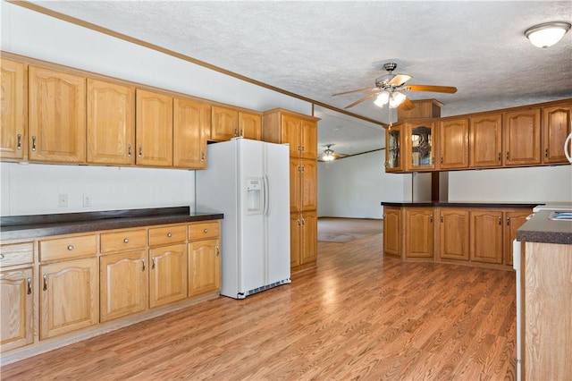 kitchen with white fridge with ice dispenser, ceiling fan, a textured ceiling, brown cabinetry, and light wood finished floors