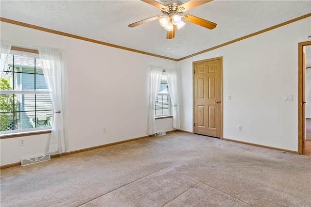 unfurnished bedroom with light carpet, crown molding, baseboards, ceiling fan, and vaulted ceiling