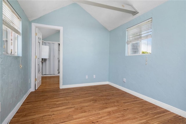 1 Offshore Rd Unit 32, Narragansett, RI 02882 - unfurnished bedroom with vaulted ceiling, wood finished floors, and baseboards
