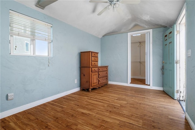 1 Offshore Rd Unit 32, Narragansett, RI 02882 - unfurnished bedroom with wood finished floors, lofted ceiling, baseboards, a ceiling fan, and a closet