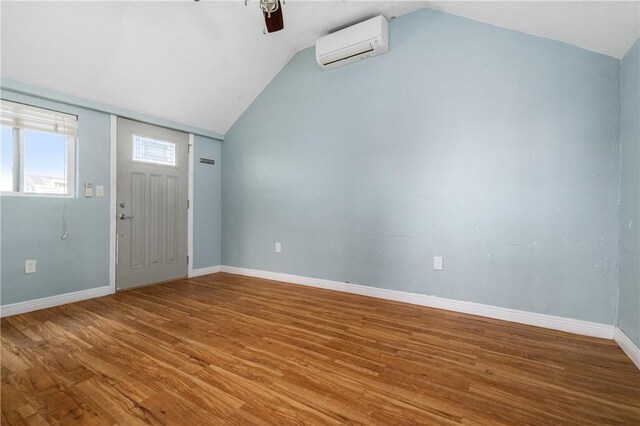 1 Offshore Rd Unit 32, Narragansett, RI 02882 - entrance foyer with an AC wall unit, vaulted ceiling, ceiling fan, wood finished floors, and baseboards