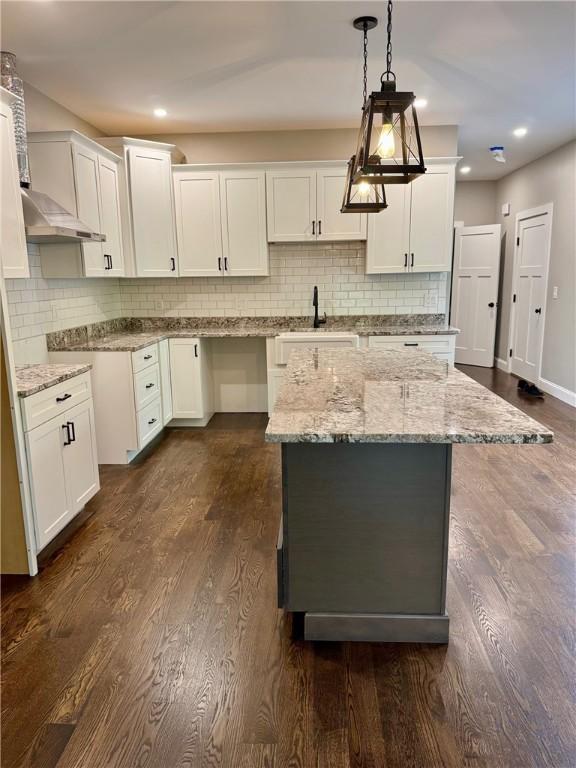 390 Lapham Farm Rd, Burrillville, RI 02859 - kitchen with light stone counters, backsplash, pendant lighting, white cabinetry, and recessed lighting