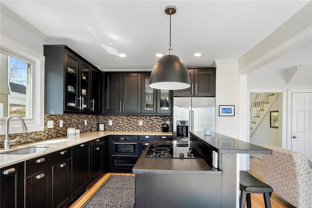 29 Webster St, Newport, RI 02840 - kitchen with a sink, black appliances, a center island, backsplash, and recessed lighting