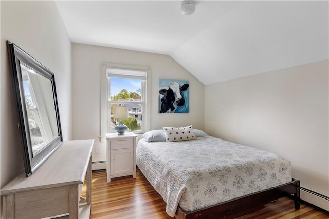 29 Webster St, Newport, RI 02840 - bedroom with baseboard heating, wood finished floors, and vaulted ceiling