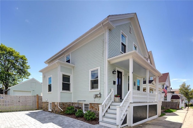 29 Webster St, Newport, RI 02840 - view of front of home with covered porch, fence, an outdoor structure, and stairs