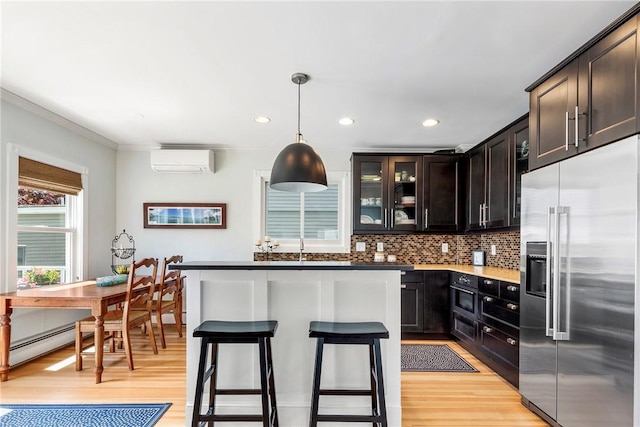 29 Webster St, Newport, RI 02840 - kitchen featuring high end fridge, baseboard heating, a wall unit AC, light wood-type flooring, and recessed lighting