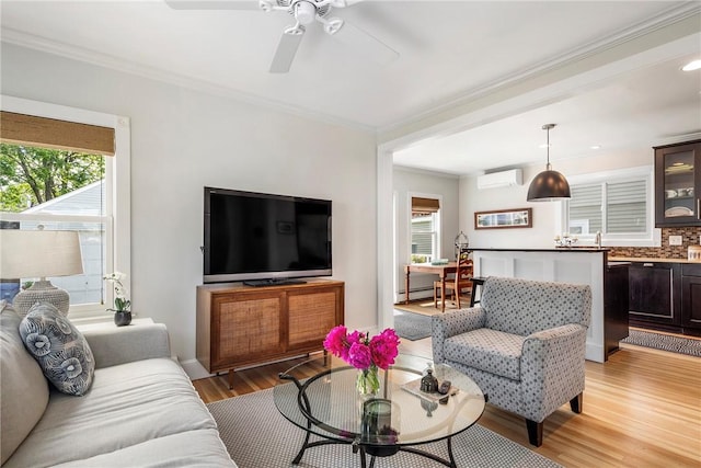 29 Webster St, Newport, RI 02840 - living area with healthy amount of natural light, an AC wall unit, light wood-style floors, ornamental molding, and ceiling fan