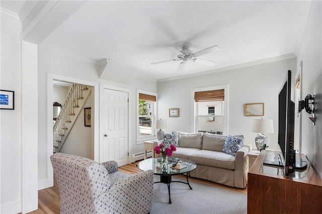 29 Webster St, Newport, RI 02840 - living room featuring baseboard heating, light wood-style floors, stairway, ornamental molding, and ceiling fan