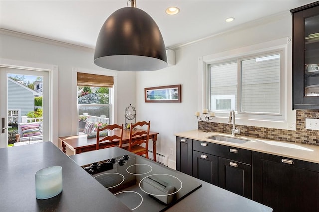 29 Webster St, Newport, RI 02840 - kitchen with a sink, ornamental molding, black electric cooktop, glass insert cabinets, and tasteful backsplash
