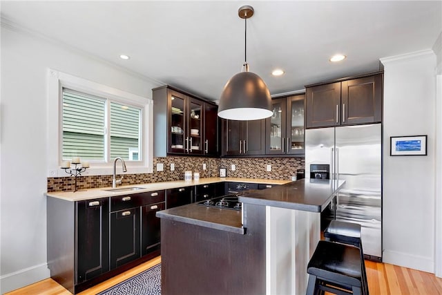 29 Webster St, Newport, RI 02840 - kitchen with a sink, stainless steel built in refrigerator, light wood finished floors, decorative backsplash, and baseboards