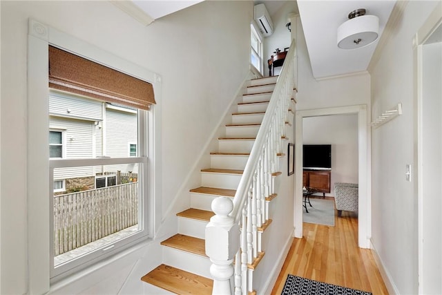 29 Webster St, Newport, RI 02840 - stairway featuring an AC wall unit, wood finished floors, and plenty of natural light