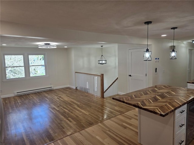 8 Centennial St, Coventry, RI 02816 - kitchen featuring a baseboard radiator, wood finished floors, white cabinetry, recessed lighting, and baseboards
