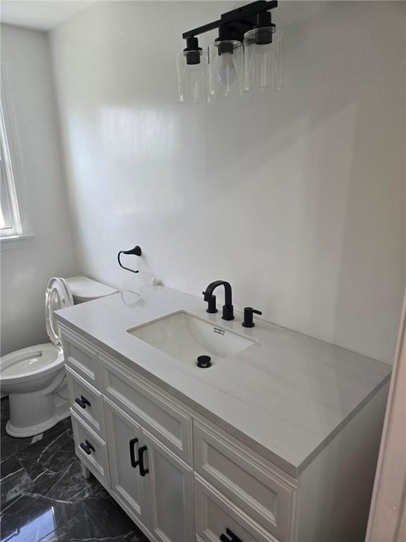 8 Centennial St, Coventry, RI 02816 - bathroom featuring marble look tile flooring, toilet, and vanity