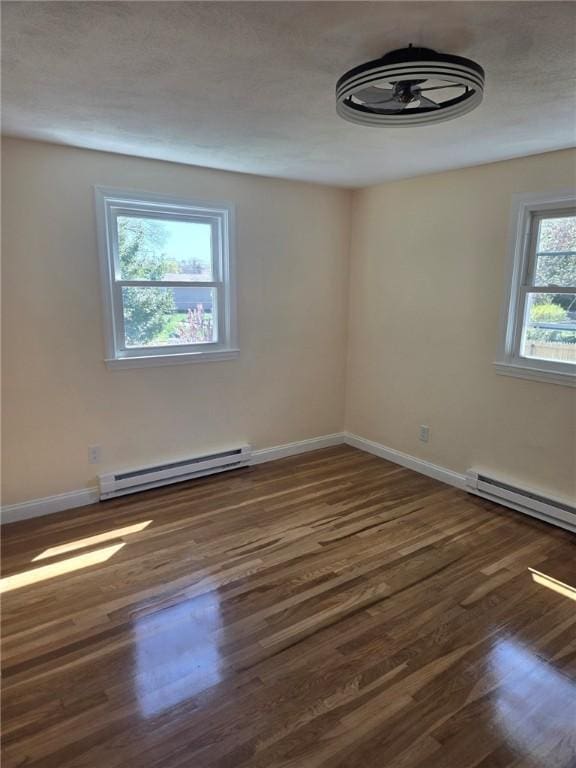 8 Centennial St, Coventry, RI 02816 - empty room featuring baseboard heating, wood finished floors, and baseboards