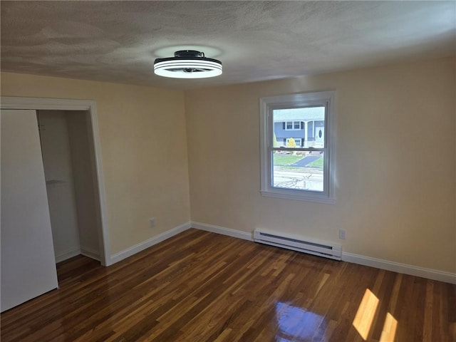 8 Centennial St, Coventry, RI 02816 - unfurnished bedroom featuring baseboard heating, baseboards, wood finished floors, a closet, and a textured ceiling