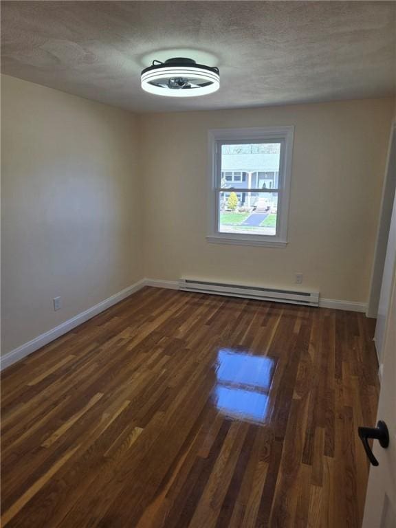 8 Centennial St, Coventry, RI 02816 - spare room with a baseboard heating unit, dark wood-style floors, and baseboards
