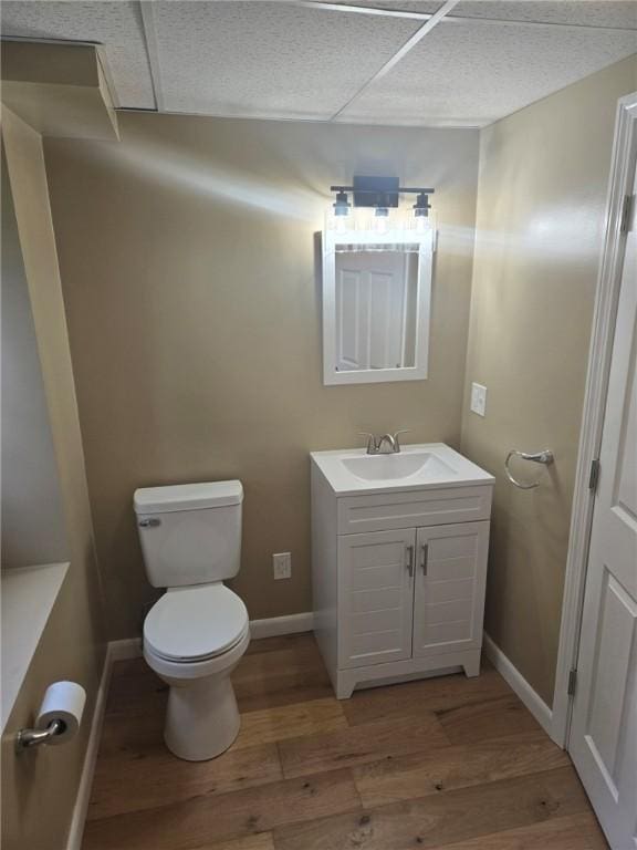 8 Centennial St, Coventry, RI 02816 - half bath featuring wood finished floors, toilet, vanity, and baseboards