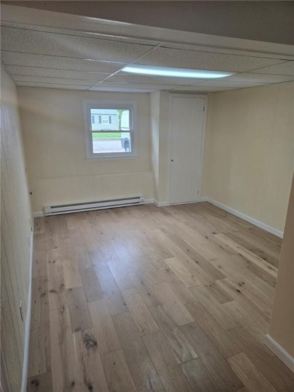 8 Centennial St, Coventry, RI 02816 - unfurnished room with a baseboard radiator, light wood-type flooring, baseboards, and a drop ceiling