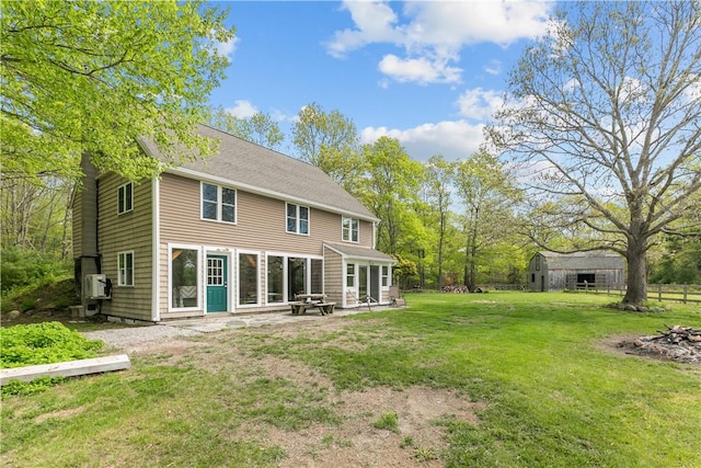 445 Plain Rd, West Greenwich, RI 02817 - back of house featuring a yard, an outdoor structure, and a patio area