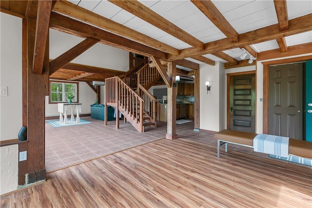 445 Plain Rd, West Greenwich, RI 02817 - unfurnished living room featuring wood finished floors, stairs, and beamed ceiling