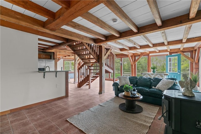 445 Plain Rd, West Greenwich, RI 02817 - living room featuring beamed ceiling, baseboards, stairs, and dark tile patterned floors