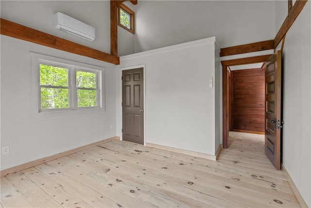 445 Plain Rd, West Greenwich, RI 02817 - spare room with a wall unit AC, plenty of natural light, light wood-style floors, and a high ceiling