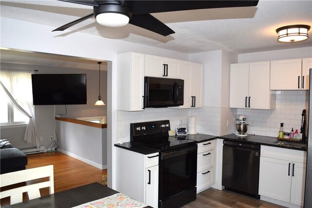 1 Watson Dr, Richmond, RI 02832 - kitchen with black appliances, decorative backsplash, white cabinetry, dark wood-type flooring, and dark countertops
