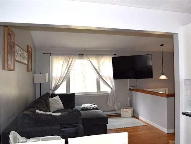 1 Watson Dr, Richmond, RI 02832 - living area with wood finished floors, a baseboard heating unit, and baseboards