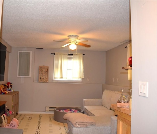 1 Watson Dr, Richmond, RI 02832 - sitting room with ceiling fan, a baseboard radiator, a textured ceiling, and baseboards