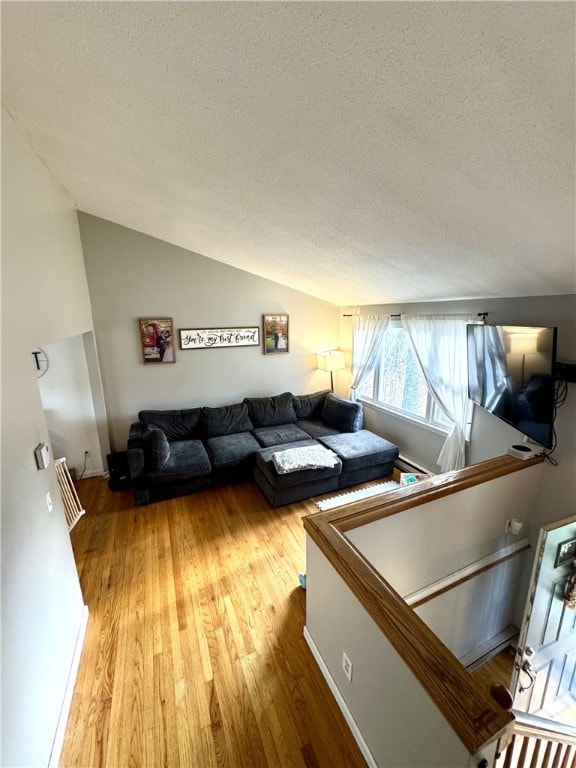 1 Watson Dr, Richmond, RI 02832 - living room featuring a textured ceiling, lofted ceiling, and wood finished floors