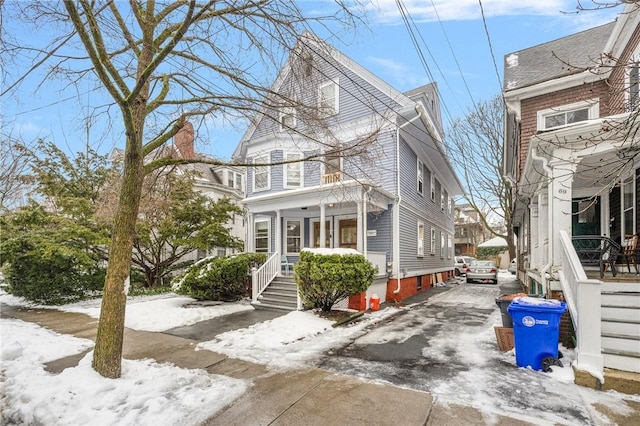 view of snow covered exterior with driveway