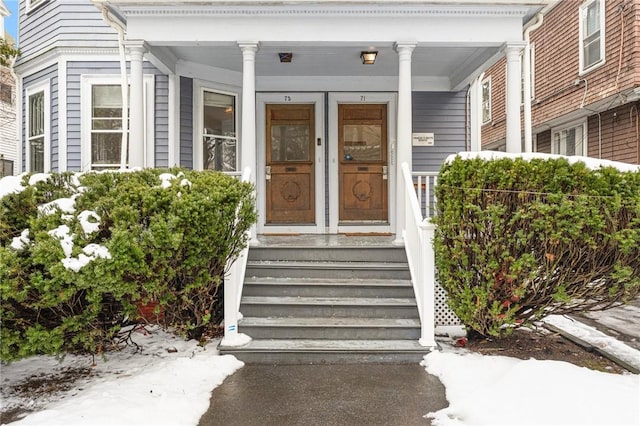 view of exterior entry with covered porch