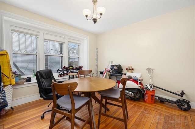 dining space with light wood-style floors and baseboards