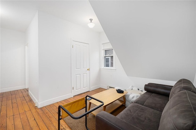 living room featuring light wood-type flooring, baseboards, and baseboard heating