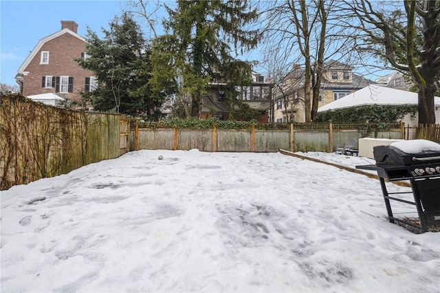 yard covered in snow with fence