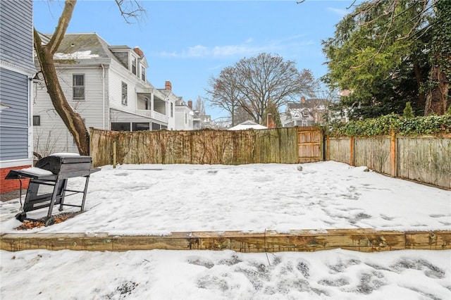 snowy yard with fence