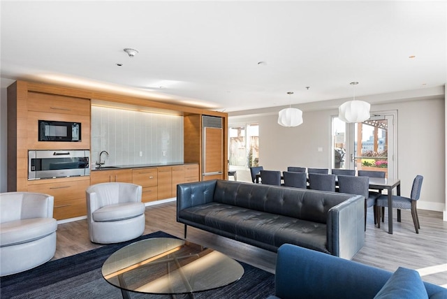 living area with light wood finished floors and baseboards