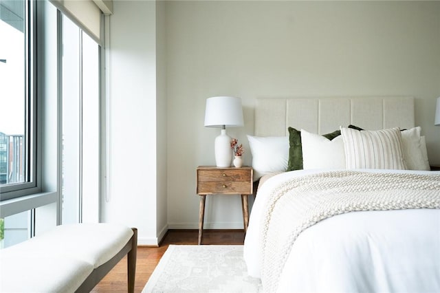bedroom featuring wood finished floors and baseboards