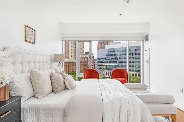 bedroom with baseboards and wood finished floors