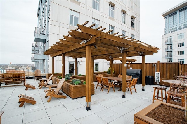 view of patio with outdoor dining area, a pergola, grilling area, and fence