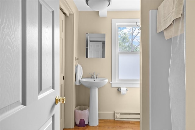 8001 Post Rd, North Kingstown, RI 02852 - bathroom with a baseboard radiator, wood finished floors, and baseboards