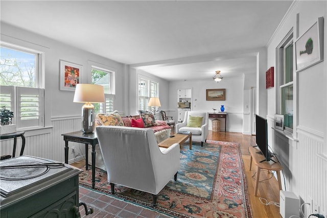 8001 Post Rd, North Kingstown, RI 02852 - living room featuring wainscoting, healthy amount of natural light, and dark wood finished floors