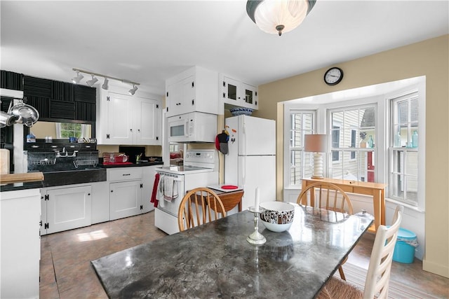 8001 Post Rd, North Kingstown, RI 02852 - dining space featuring healthy amount of natural light, rail lighting, and light tile patterned flooring