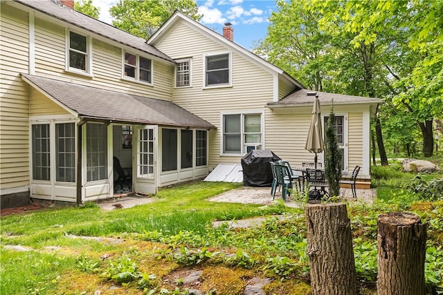 8001 Post Rd, North Kingstown, RI 02852 - back of house with a chimney, a sunroom, a shingled roof, and a patio area