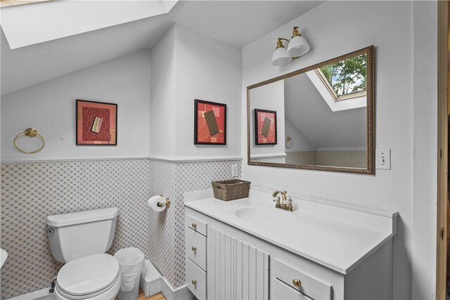 8001 Post Rd, North Kingstown, RI 02852 - bathroom featuring a skylight, toilet, wainscoting, vanity, and lofted ceiling